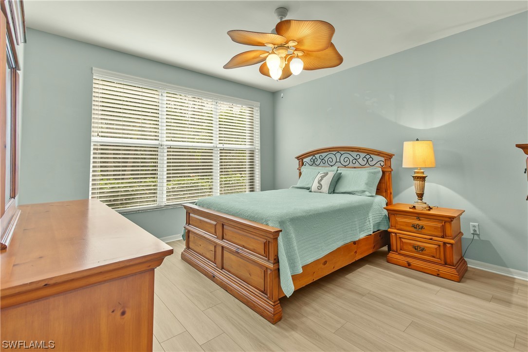9575 Hemingway Lane, Unit 4410 Fort Myers, FL 33913 - Photo 8 of 23 a bedroom with a bed and a chandelier