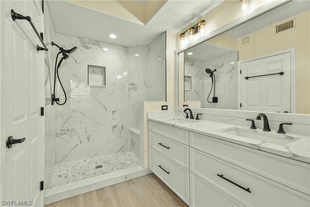 9575 Hemingway Lane, Unit 4410 Fort Myers, FL 33913 - Photo 9 of 23 a bathroom with a double vanity sink mirror double and shower