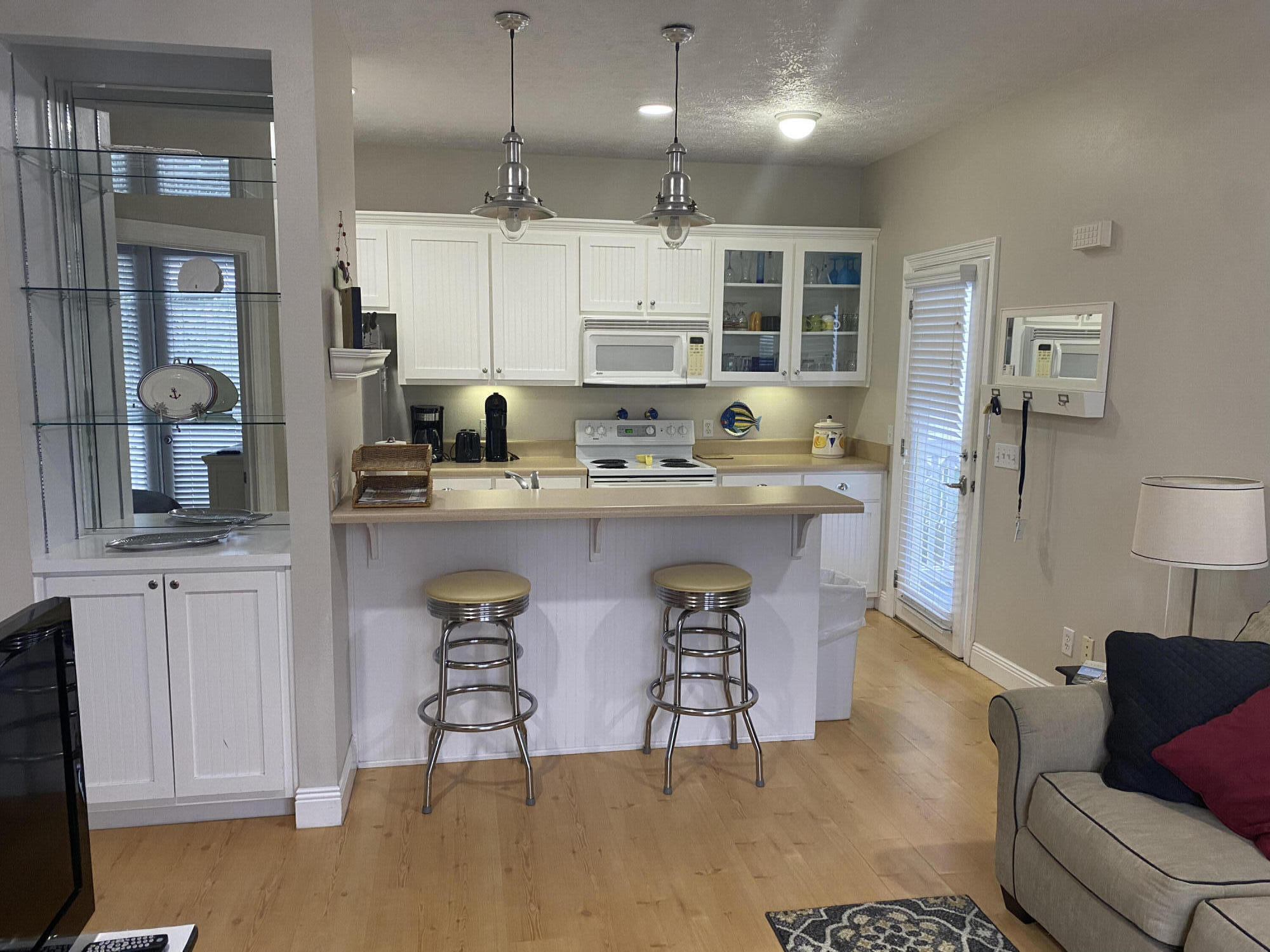 9 East Blue Crab Loop Inlet Beach, FL 32461 - Photo 36 of 55 a kitchen with kitchen island a sink a stove a refrigerator and white cabinets