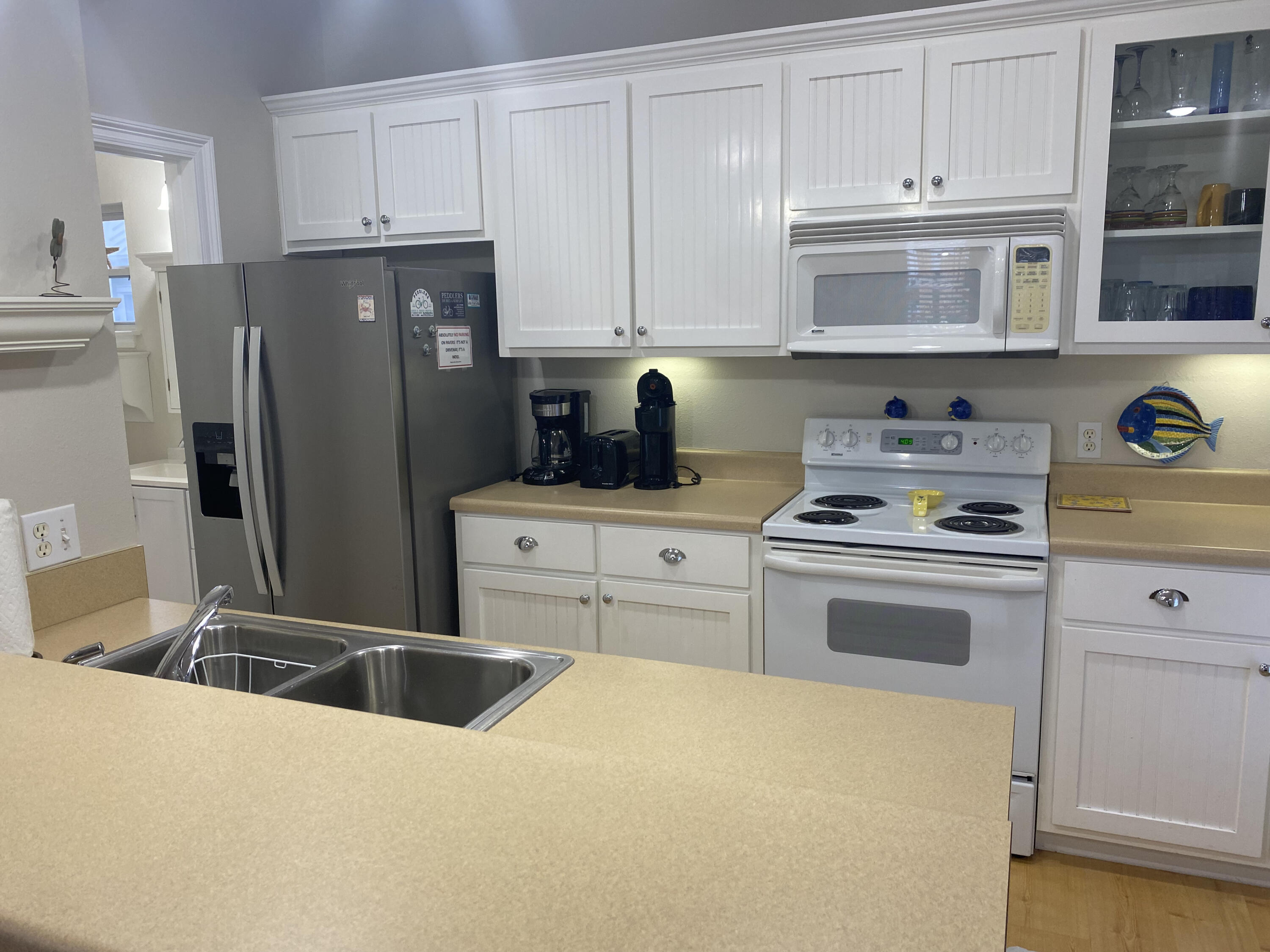 9 East Blue Crab Loop Inlet Beach, FL 32461 - Photo 37 of 55 a kitchen with a refrigerator sink and cabinets