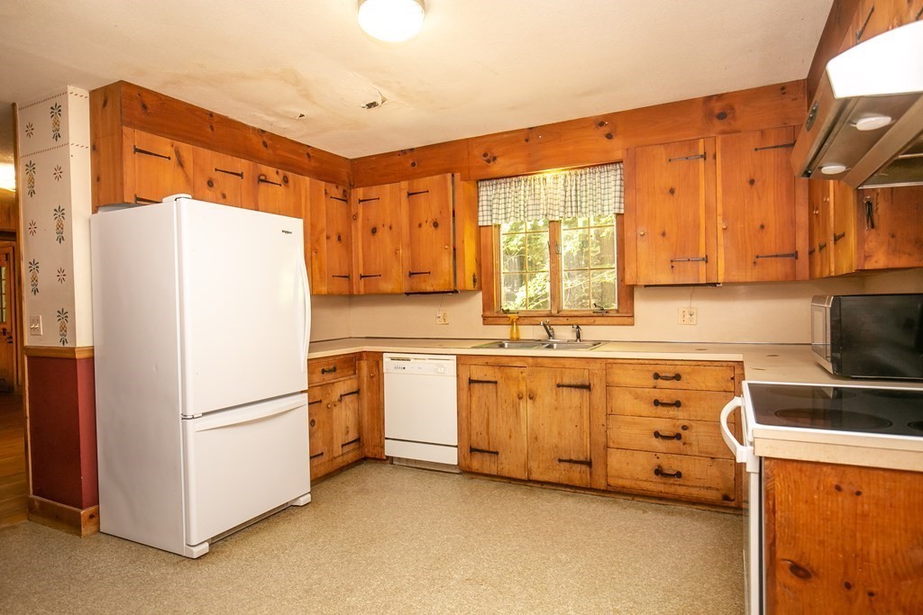 35 Juggler Meadow Road Leverett, MA 01054 - Photo 11 of 40 a kitchen with stainless steel appliances a refrigerator sink and cabinets