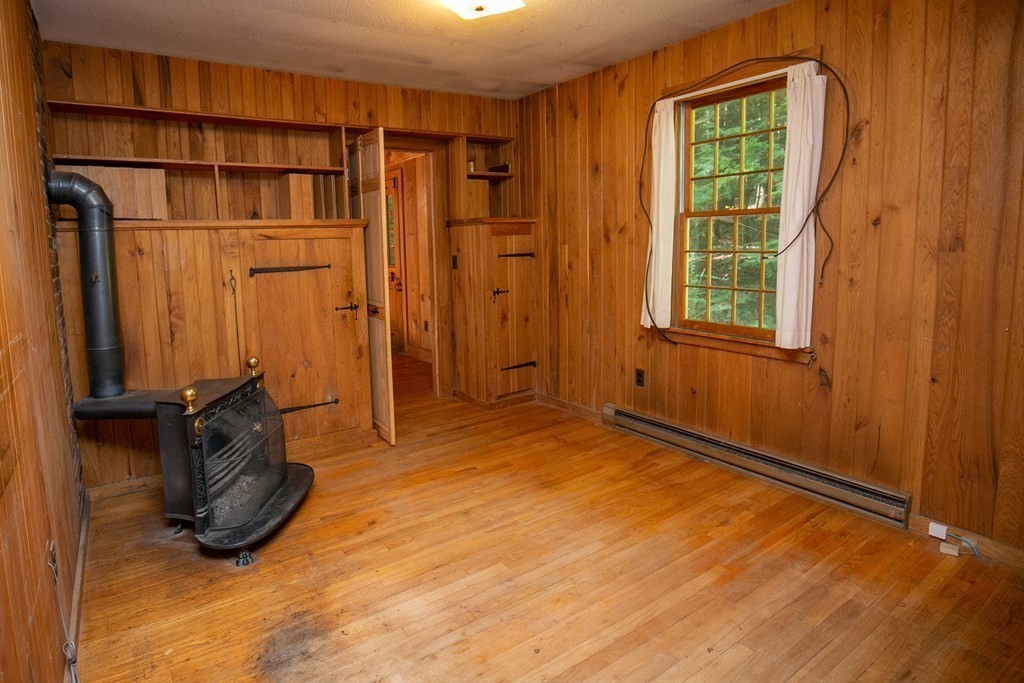 35 Juggler Meadow Road Leverett, MA 01054 - Photo 16 of 40 an empty room with a fireplace and windows