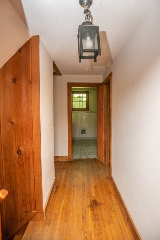35 Juggler Meadow Road Leverett, MA 01054 - Photo 22 of 40 a view of a hallway with wooden floor and a bathroom