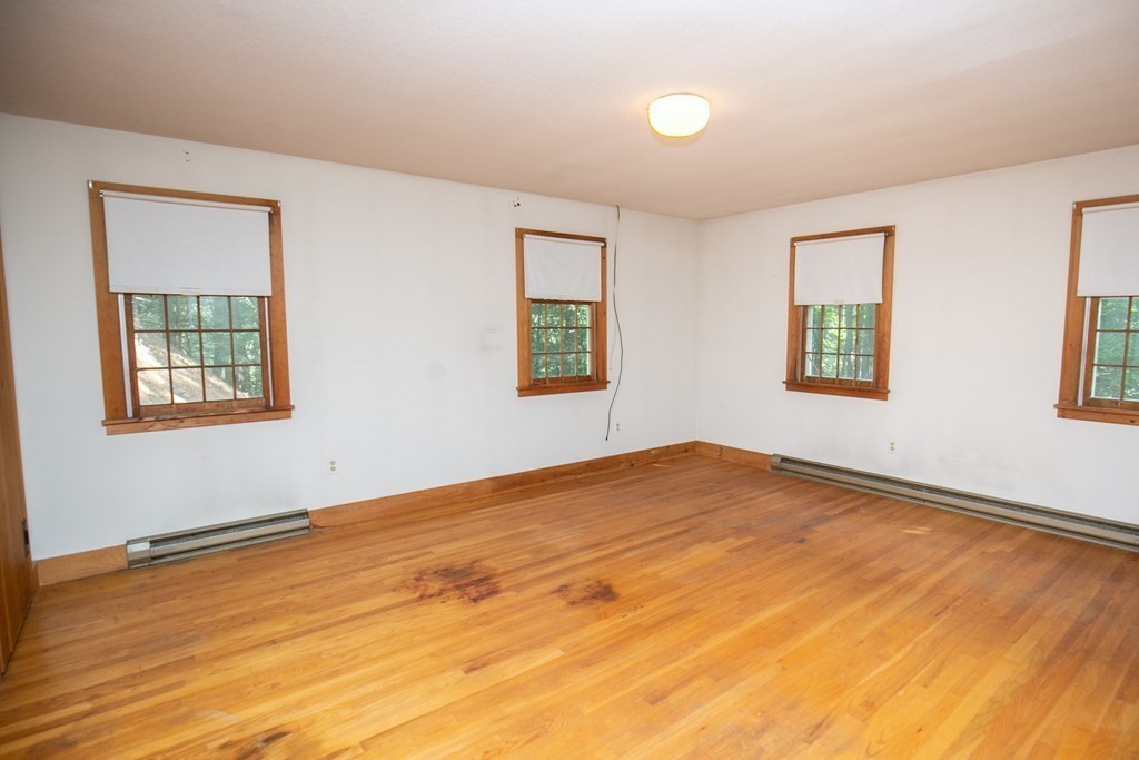 35 Juggler Meadow Road Leverett, MA 01054 - Photo 23 of 40 a view of an empty room with wooden floor and a window