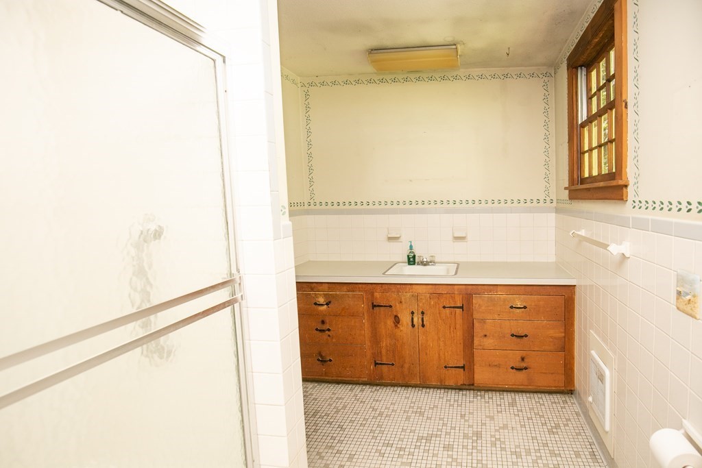 35 Juggler Meadow Road Leverett, MA 01054 - Photo 28 of 40 a bathroom with a double vanity sink and mirror