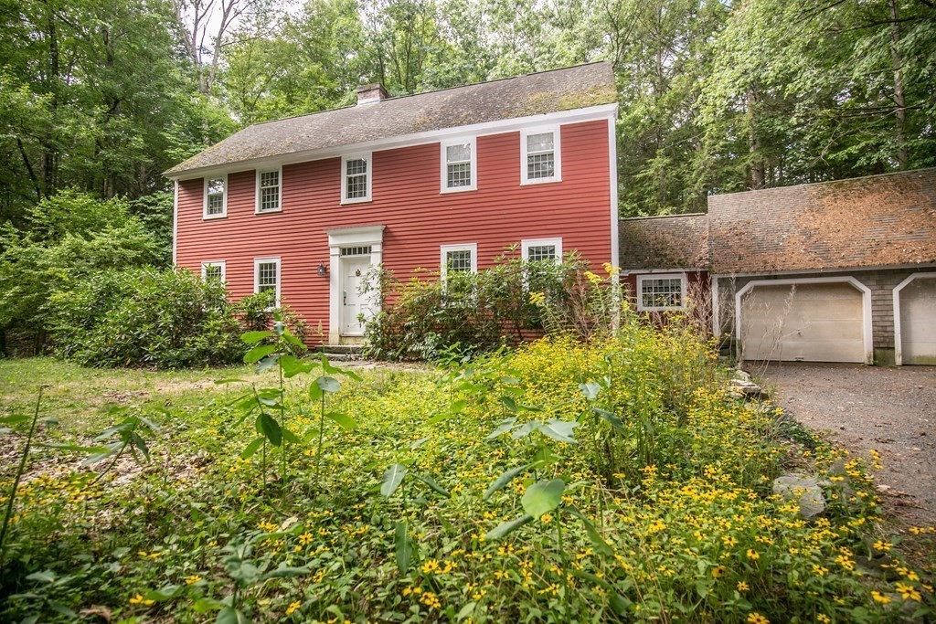 35 Juggler Meadow Road Leverett, MA 01054 - Photo 40 of 40 a front view of a house with a yard and garage