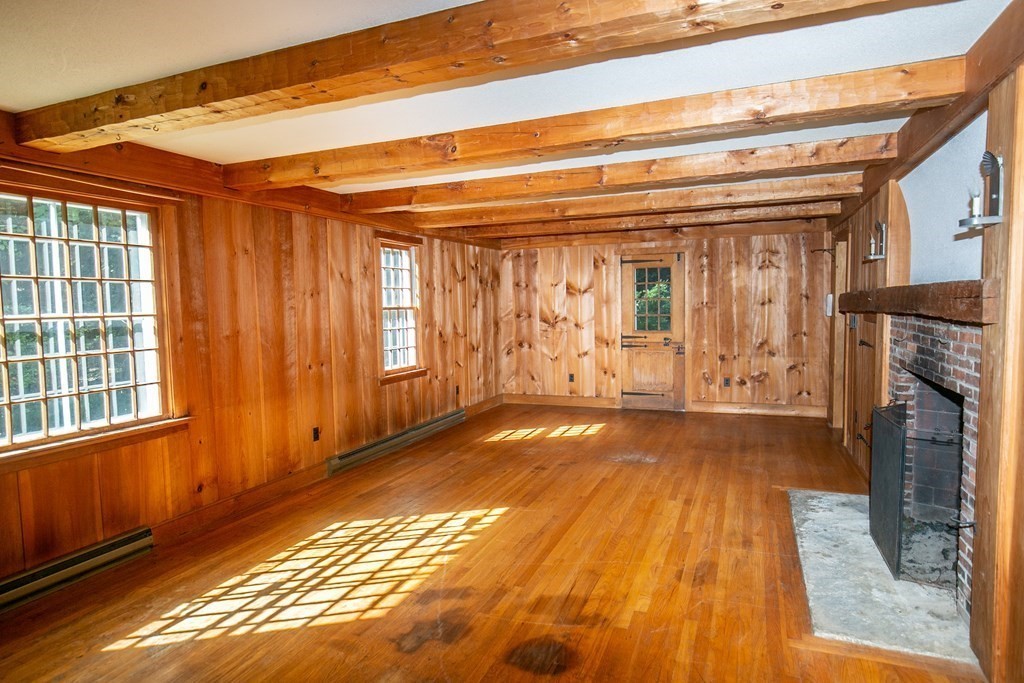 35 Juggler Meadow Road Leverett, MA 01054 - Photo 6 of 40 a view of an empty room with wooden floor and a window