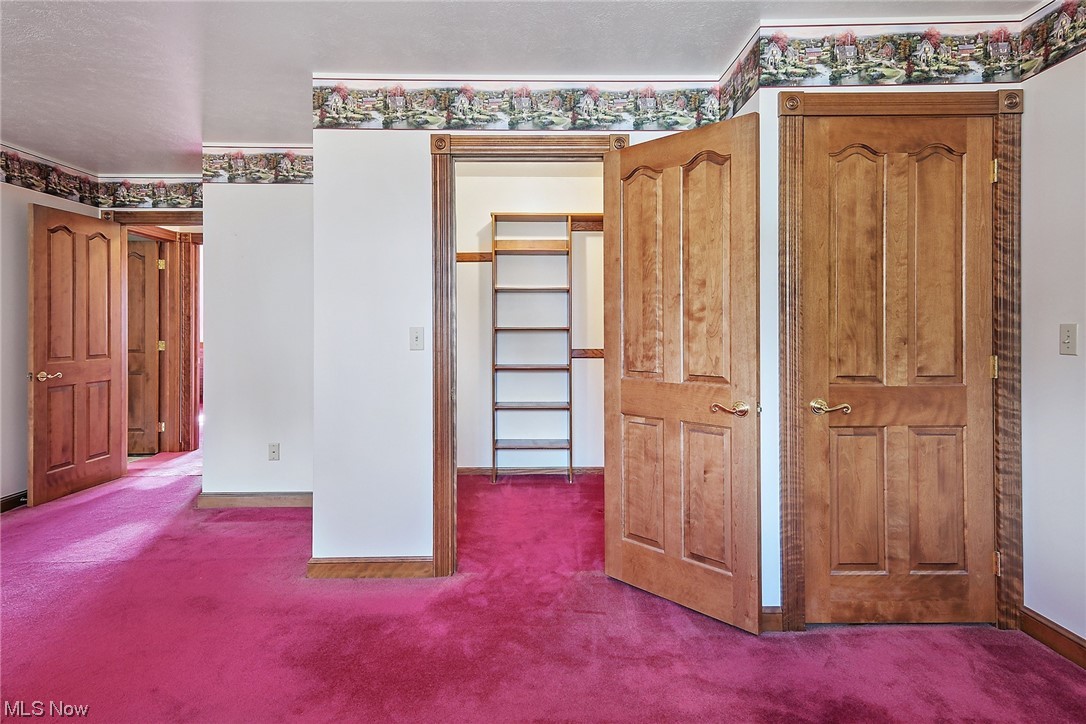 2753 Tabor Ridge Road Northeast Mineral City, OH 44656 - Photo 33 of 41 Unfurnished bedroom featuring a closet, a spacious closet, and carpet