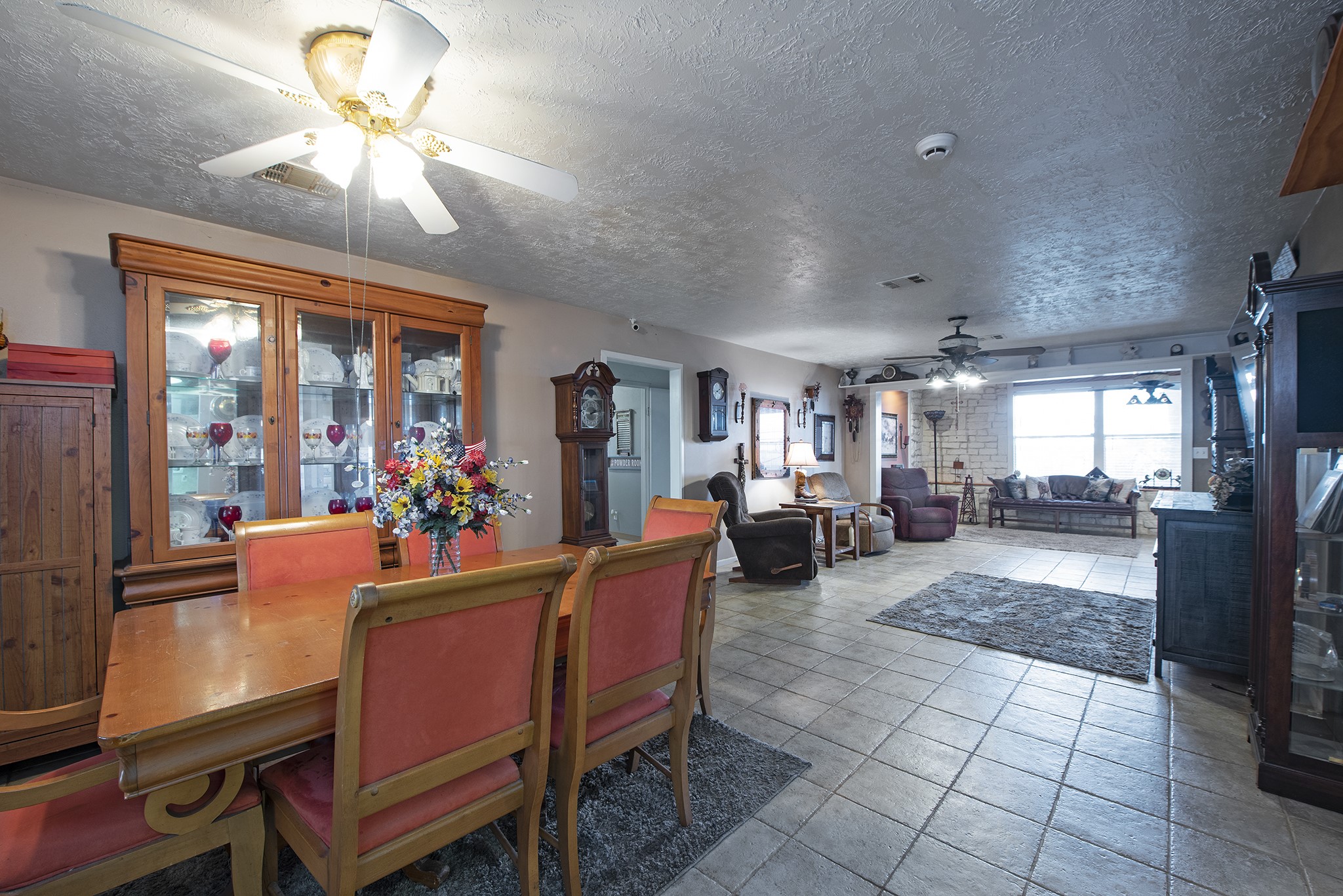 22234 Castle Road Waller, TX 77484 - Photo 21 of 50 a living room with furniture a chandelier and a dining table