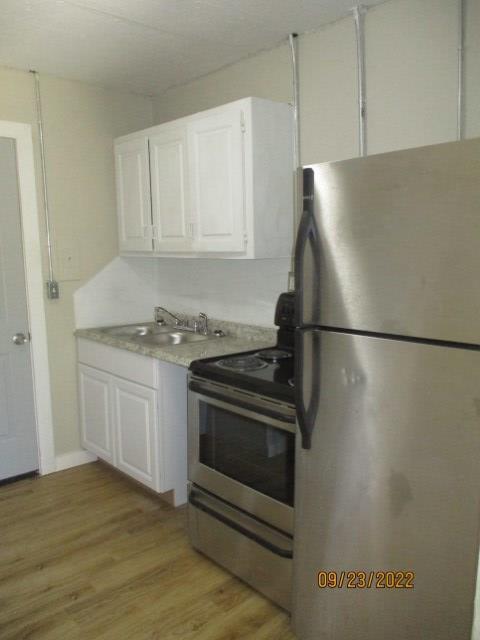 758 Terminal Street, Unit 4 Columbus, GA 31906 - Photo 5 of 21 a kitchen with granite countertop a refrigerator and a stove top oven