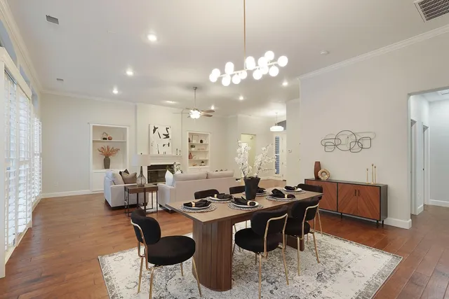 a kitchen with a stove a sink dishwasher and white cabinets with wooden floor