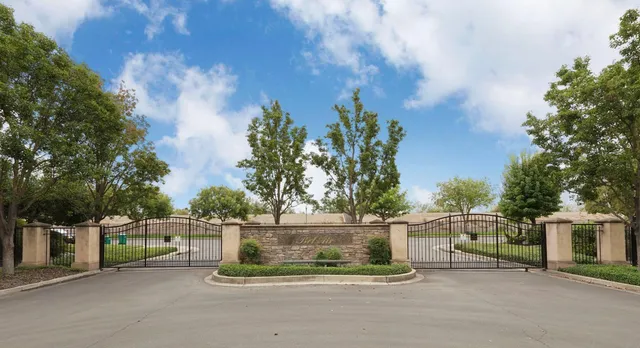 front view of a house with a yard and potted plants