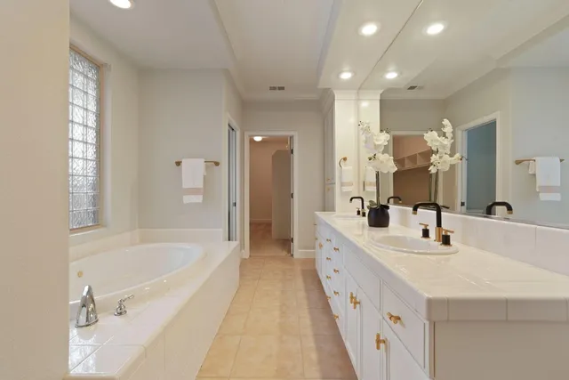 a view of backyard with large tree and wooden fence