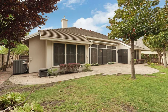 an aerial view of a house with a yard and large trees