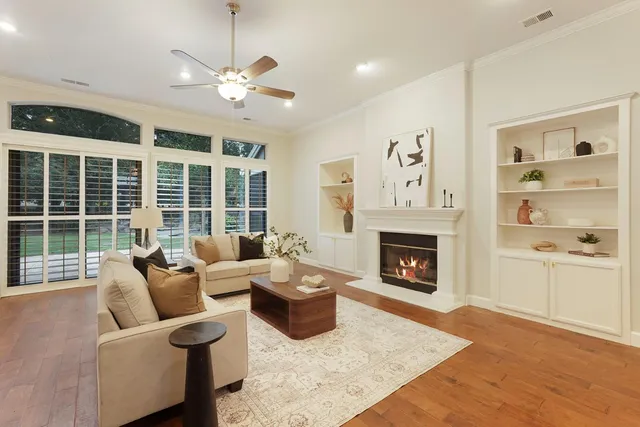 a living room with furniture kitchen view and a chandelier