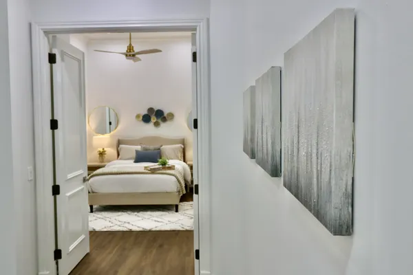 a bedroom with a bed and a painting on the wall