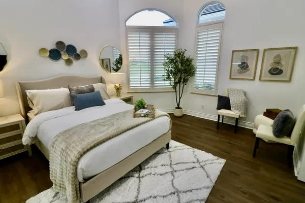 a spacious bedroom with bed and a large window