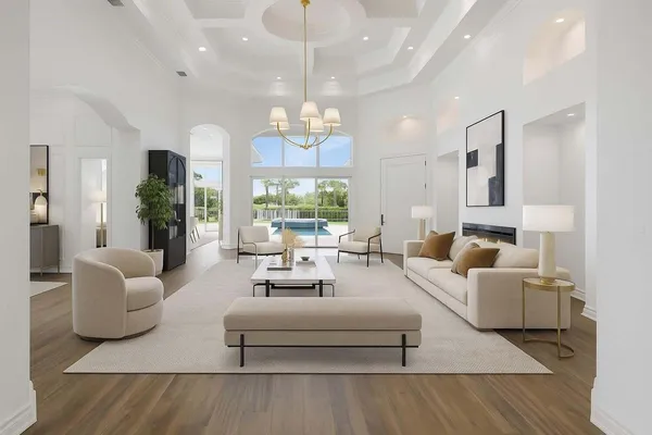 a living room with furniture or chandelier and a wooden floor