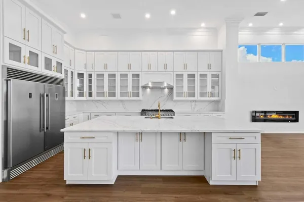 a kitchen with stainless steel appliances granite countertop a stove and a refrigerator