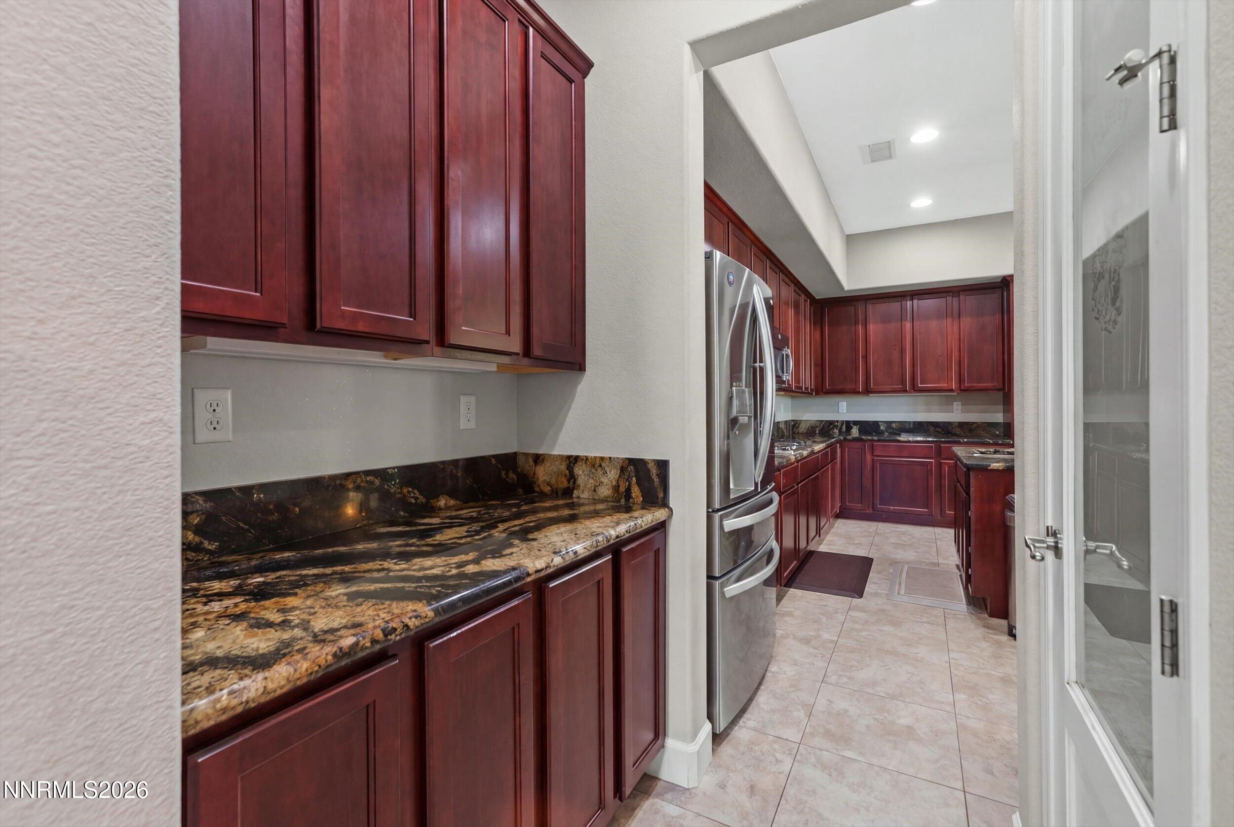 2920 Bull Rider Drive Reno, NV 89521 - Photo 8 of 51 a kitchen with stainless steel appliances granite countertop a stove sink and cabinets