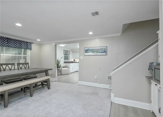 a kitchen with granite countertop white cabinets and white stainless steel appliances
