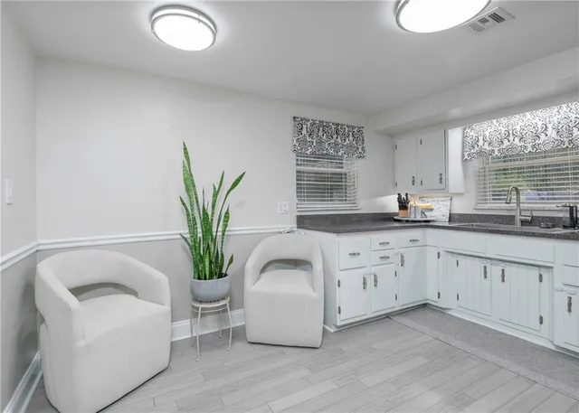 a kitchen with stainless steel appliances a refrigerator and a couch