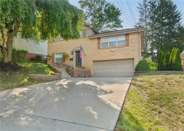 a view of a backyard with a garden and tree
