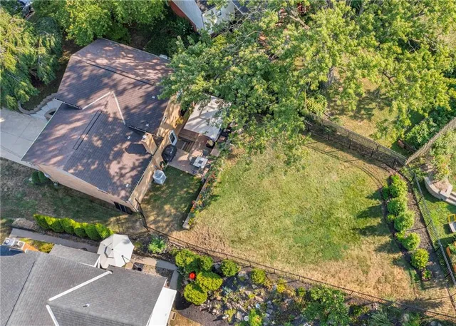 an aerial view of a house with a yard basket ball court