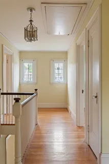 an empty room with wooden floor and a window