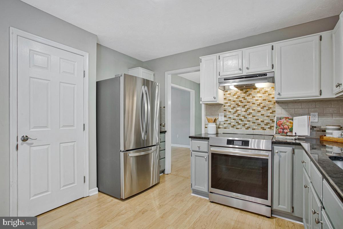 8401 Triple Crown Road Bowie, MD 20715 - Photo 11 of 44 Microwave tucked in nook beside fridge