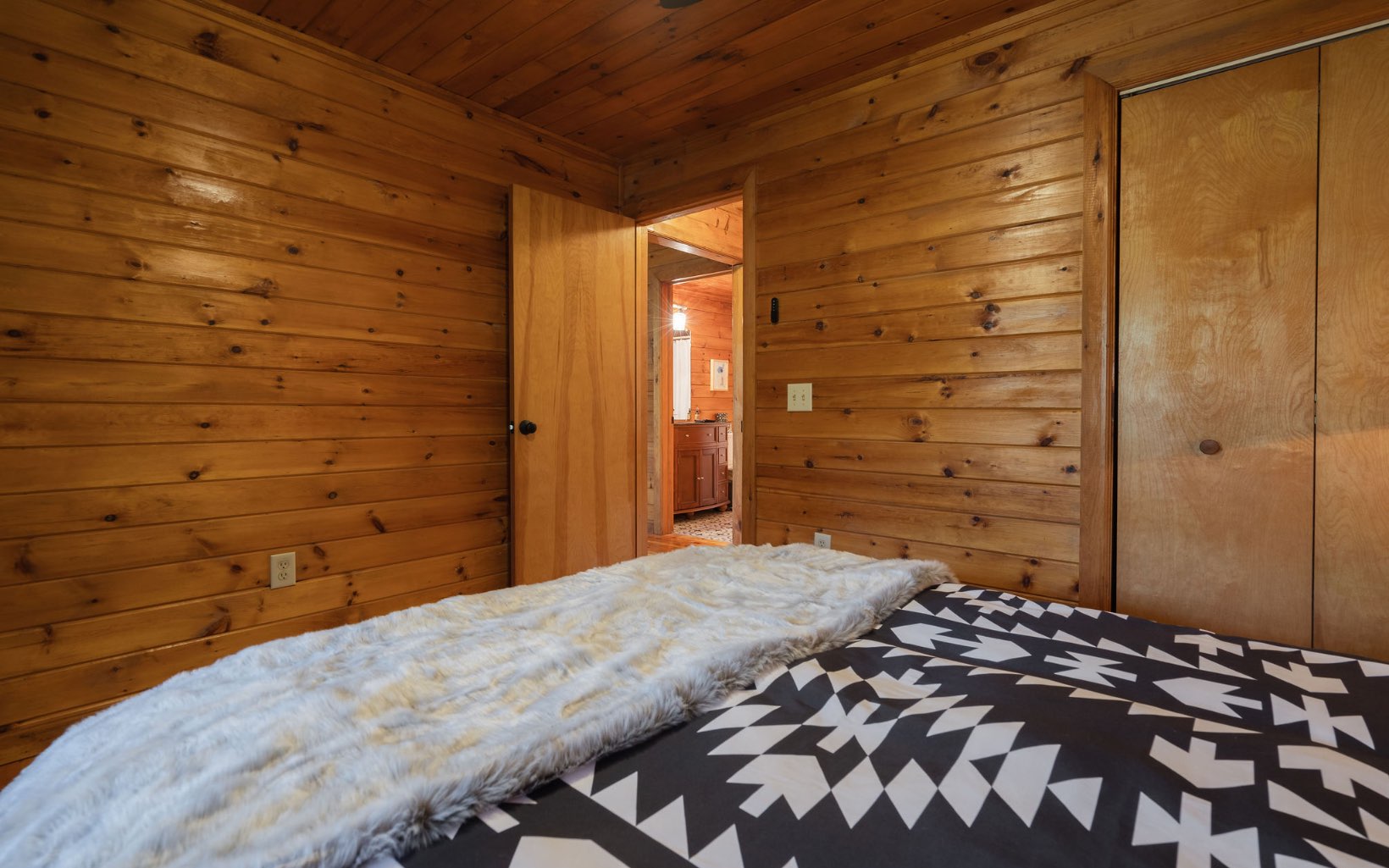 1311 Little Bushy Head Road Blue Ridge, GA 30513 - Photo 21 of 39 a bedroom with a bed and a wooden floor