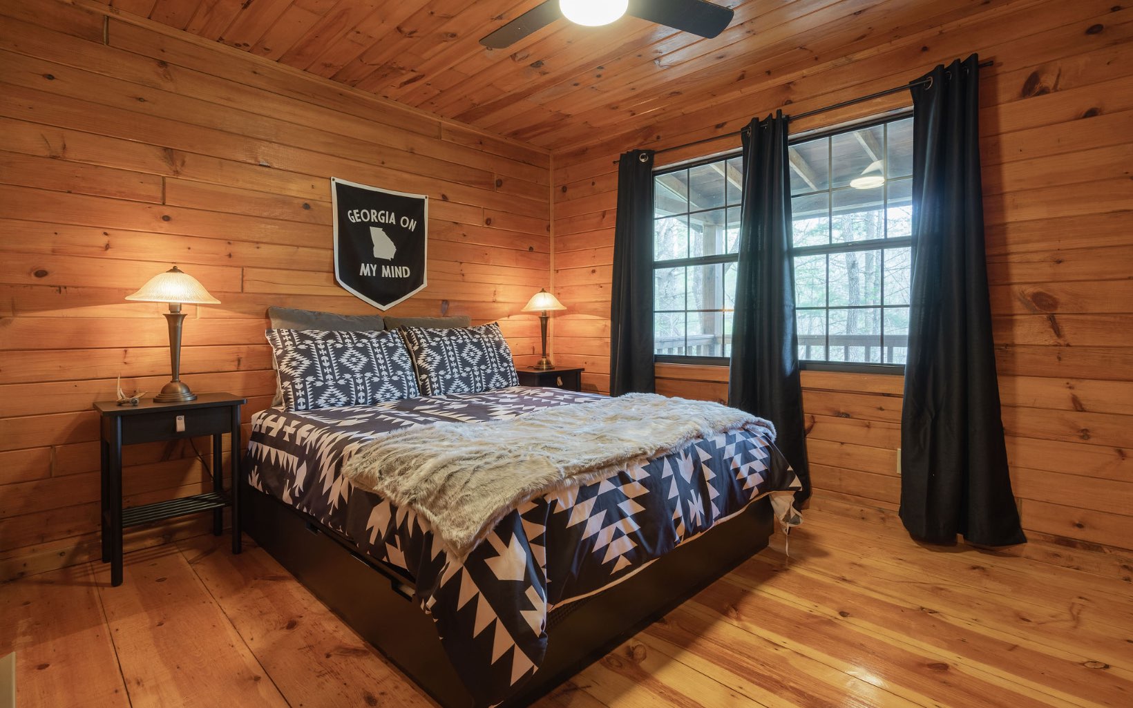 1311 Little Bushy Head Road Blue Ridge, GA 30513 - Photo 8 of 39 a bedroom with a bed and wooden floor