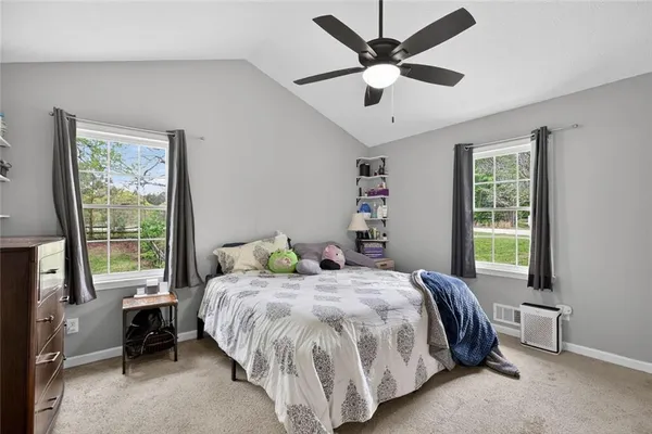 a bedroom with a bed and a large window