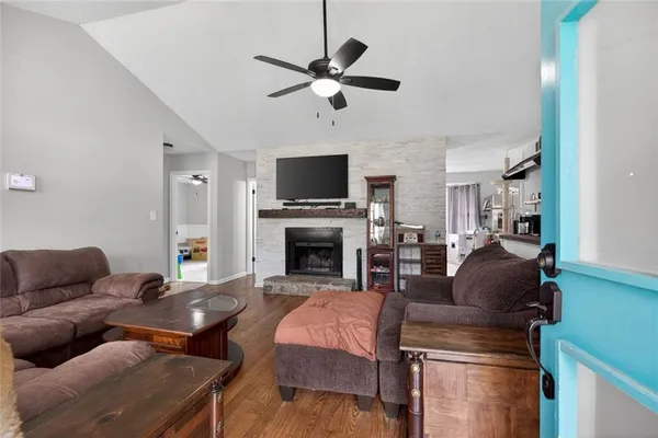 a living room with furniture a fireplace and a flat screen tv