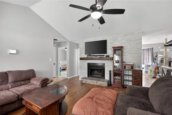 a living room with furniture a flat screen tv and a fireplace