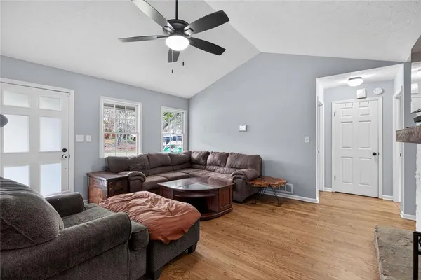a living room with furniture and a ceiling fan