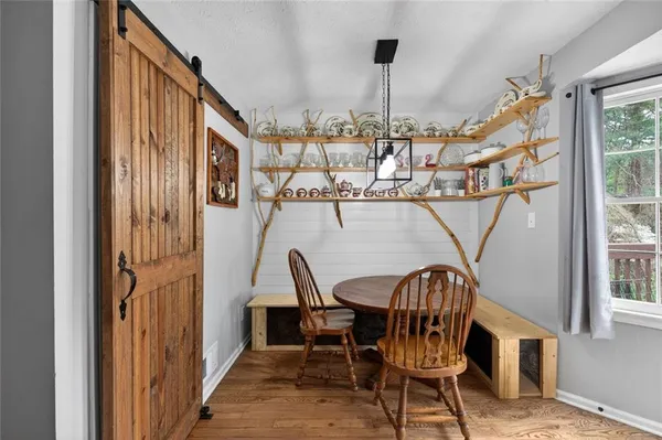a view of a chairs and table in wooden floor