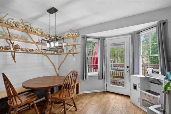 a view of a dining room with furniture window and wooden floor