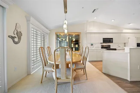 a kitchen with stainless steel appliances a refrigerator sink and white cabinets