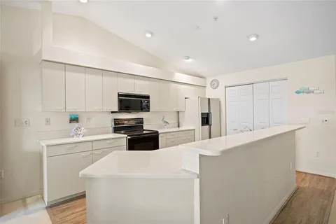 a kitchen with a sink and a stove top oven