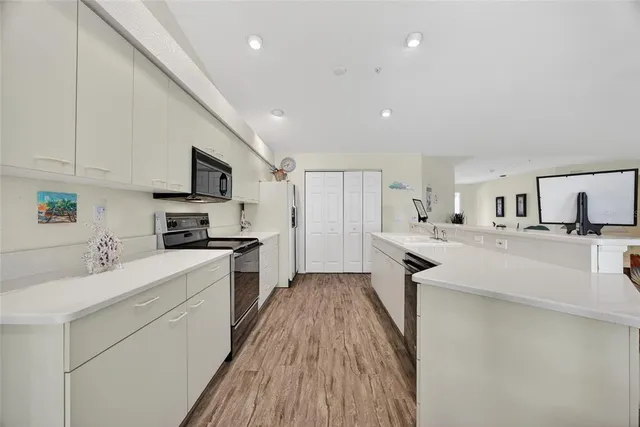 a view of a kitchen with appliances and cabinets