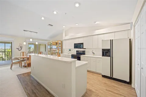 a large kitchen with stainless steel appliances lots of counter space and wooden floor