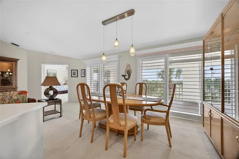 a view of a dining room with furniture large windows and wooden floor