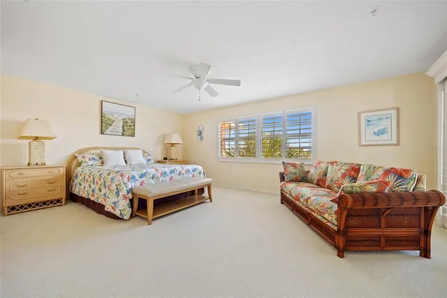 a spacious bedroom with a bed and a couch