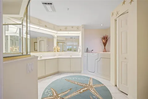 a bathroom with a granite countertop sink mirror and a shower