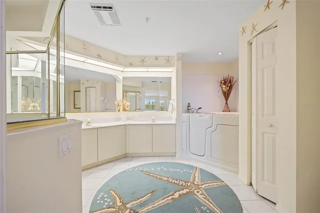 a bathroom with a granite countertop sink mirror and a shower