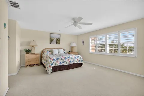 a bedroom with a large bed and a window