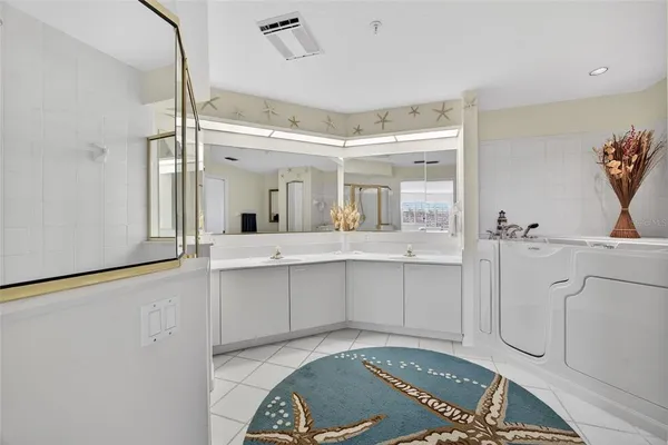 a bathroom with a shower sink and mirror