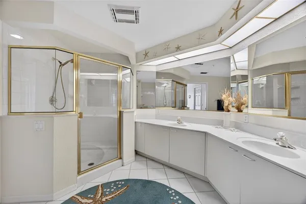 a bathroom with a double vanity sink mirror and toilet