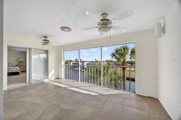 an aerial view of residential houses with outdoor space and ocean view